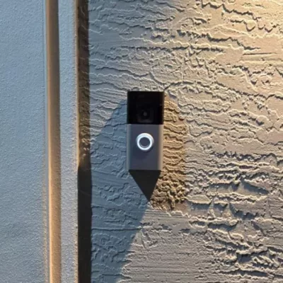 Ring Battery Doorbell Plus installed at the front of a house, providing smart home security with motion detection and two-way audio.