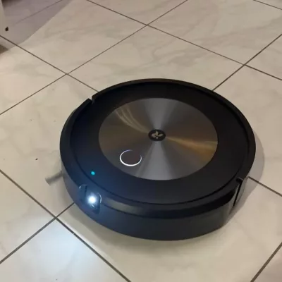 iRobot Roomba Combo j5 Plus robot vacuum cleaning a tiled floor. - Roomba Combo j5 Plus performance on carpets​ & Roomba Combo j5 Plus mopping functionality​


