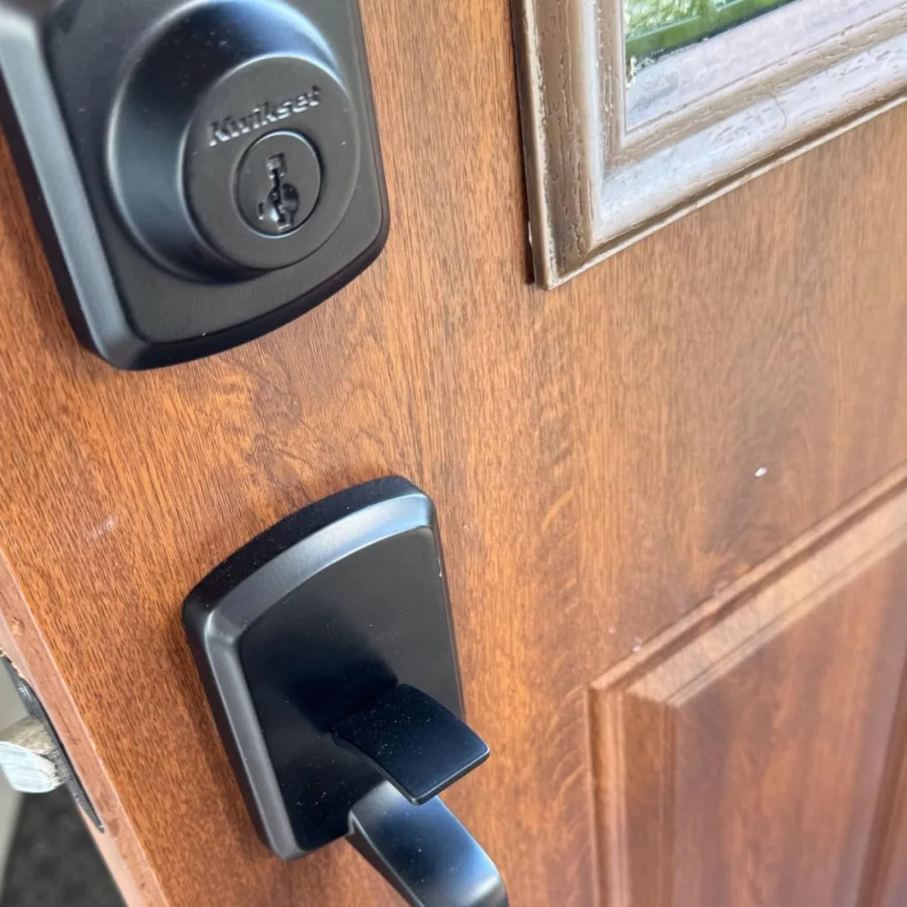 Yale August Wi-Fi Smart Lock installed on the exterior of a front door, showcasing its smart home integration and keyless entry design.