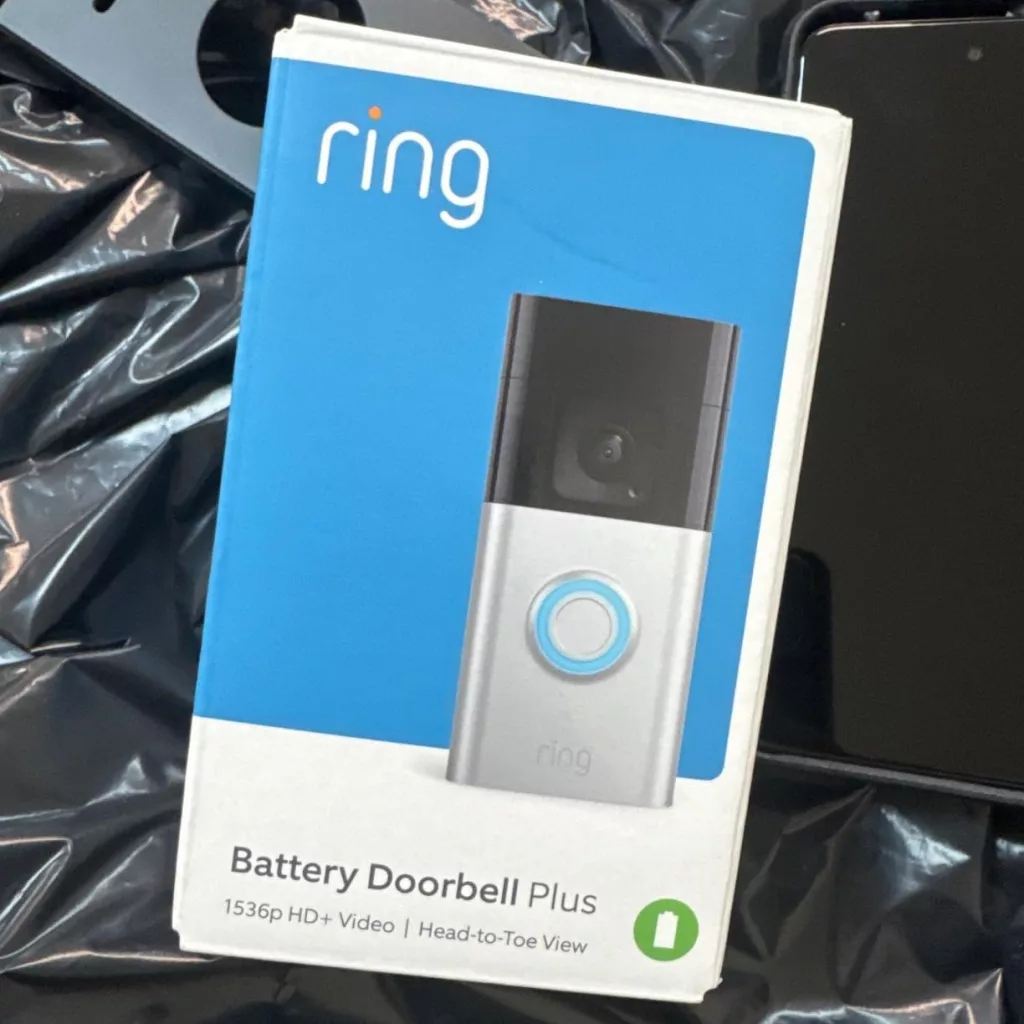 Unboxing the Ring Battery Doorbell Plus, showcasing included accessories such as the mounting bracket, battery pack, and installation tools.